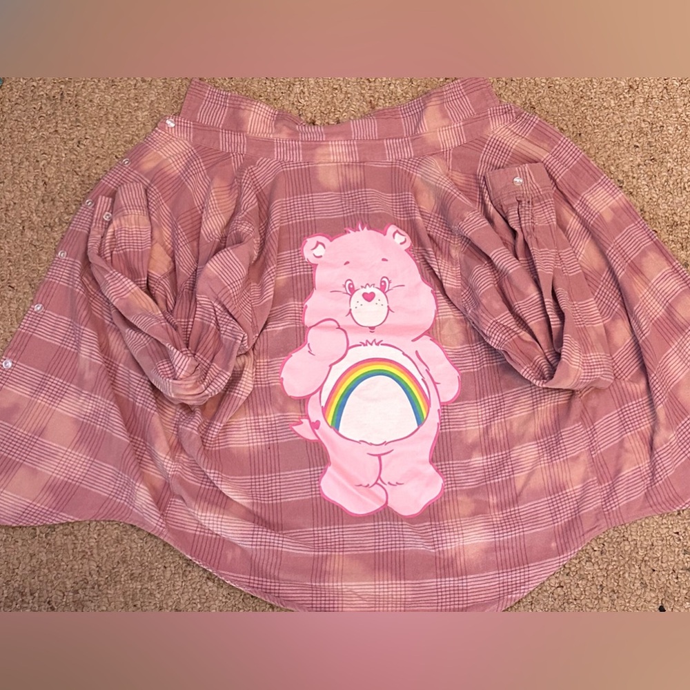 Pink button up shirt with care bear.